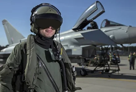 Fighter pilot wearing optically designed helmet with integrated display visor.