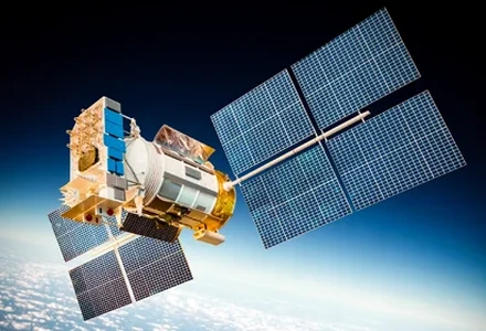 Satellite with solar panels orbiting above Earth.